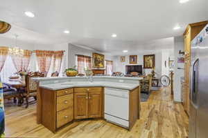 Kitchen island with light-toned countertop and integrated sink