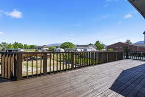 Expansive wood deck with a dark-stained railing, offering a wide open-air space