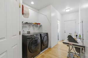 Dedicated laundry area featuring a full-size washer and dryer