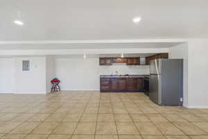 Spacious room featuring tile flooring, recessed lighting, and white walls