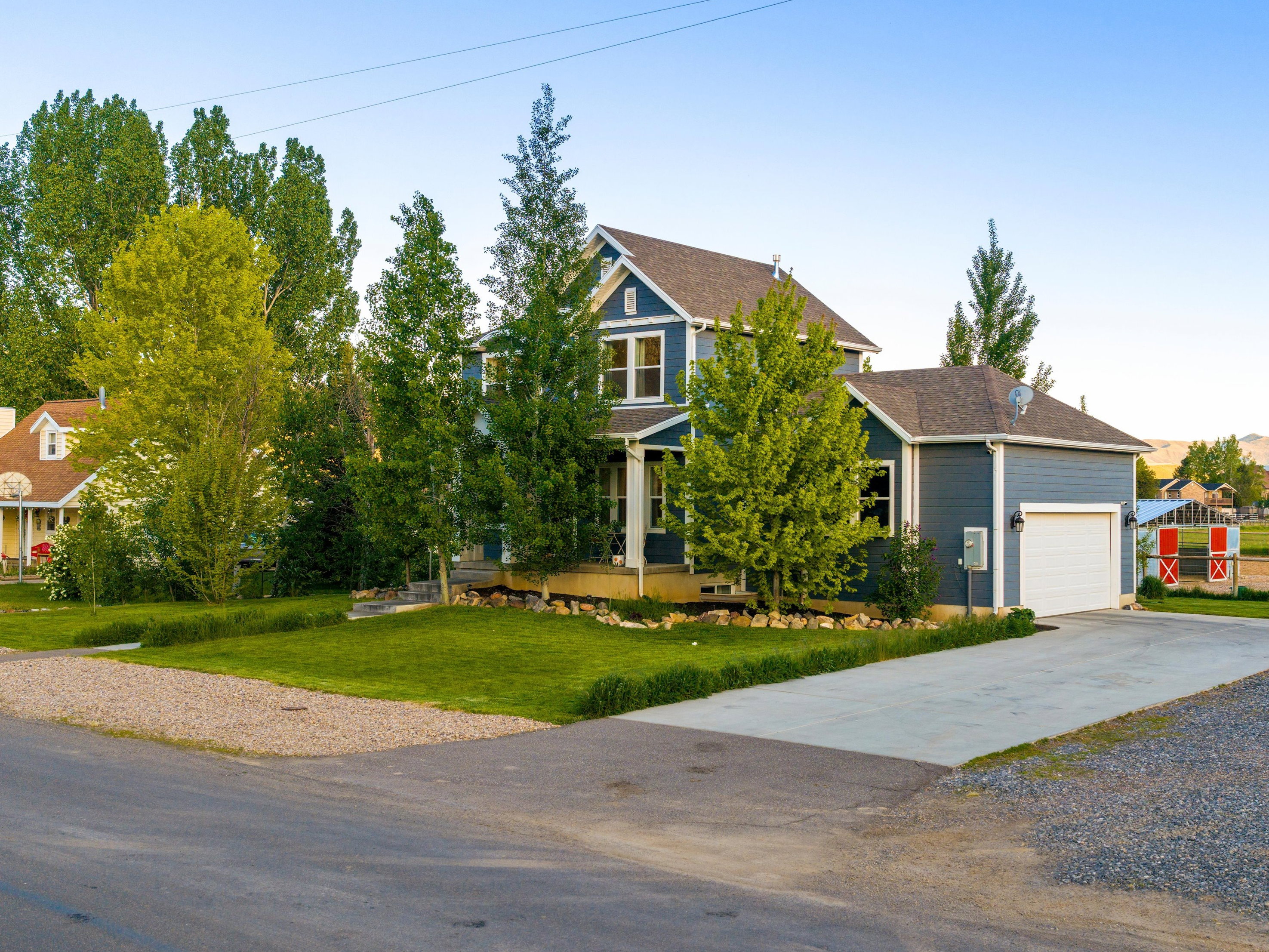 Two-story residence with blue siding, white trim, and a covered front porch
