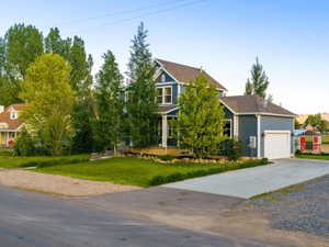 Two-story residence with blue siding, white trim, and a covered front porch