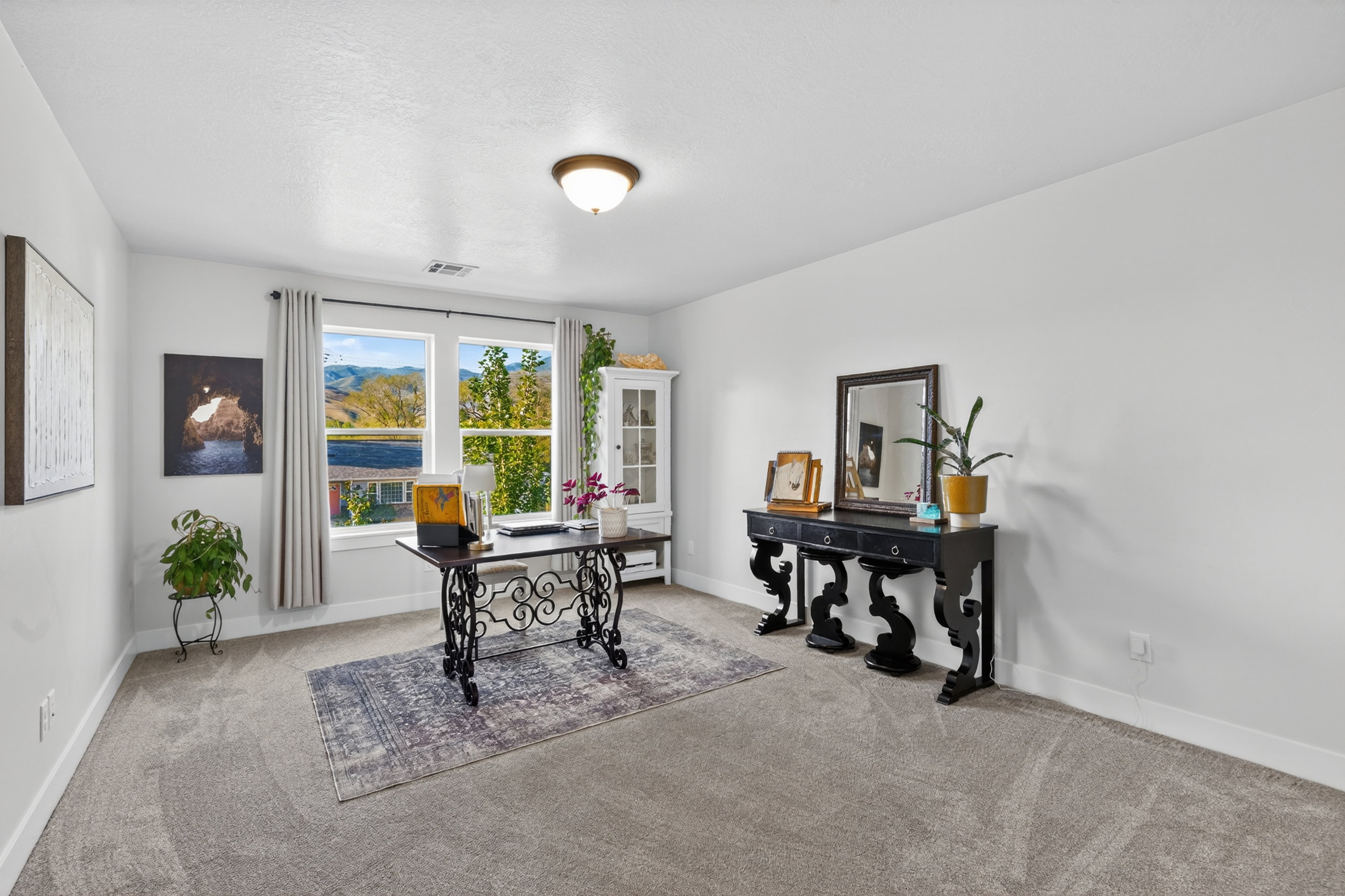 Spacious room featuring broad windows, light gray carpet, white walls, and a semi-flush mount ceiling light