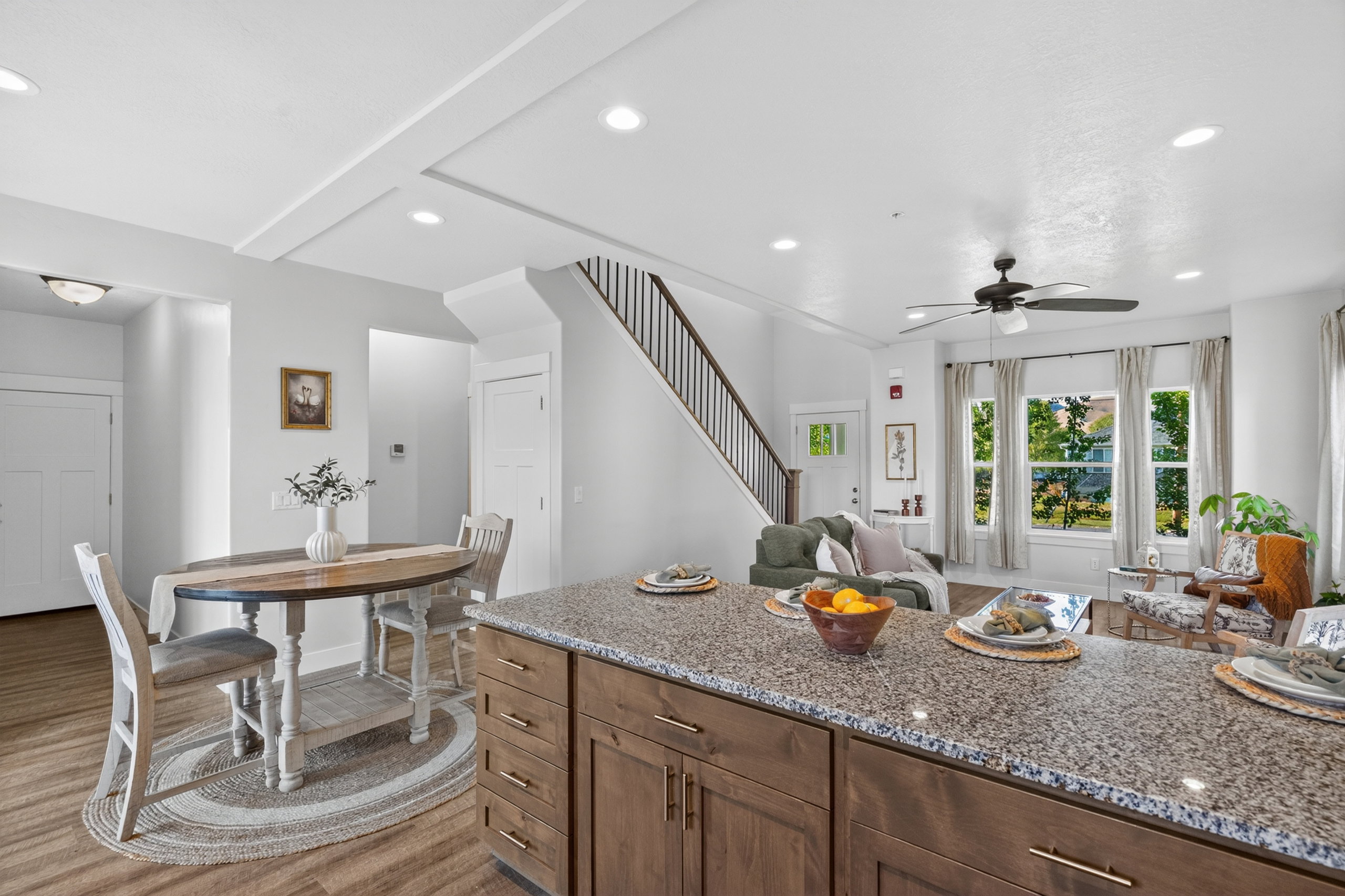 Kitchen island featuring a granite-style countertop and wood-finish cabinetry with brass hardware