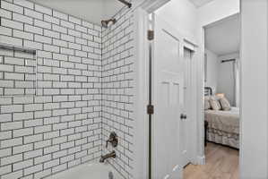 White subway tile shower surround with a built-in niche and bronze-finish fixtures