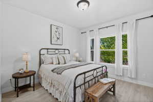 Bright room featuring light wood-finish flooring and white walls