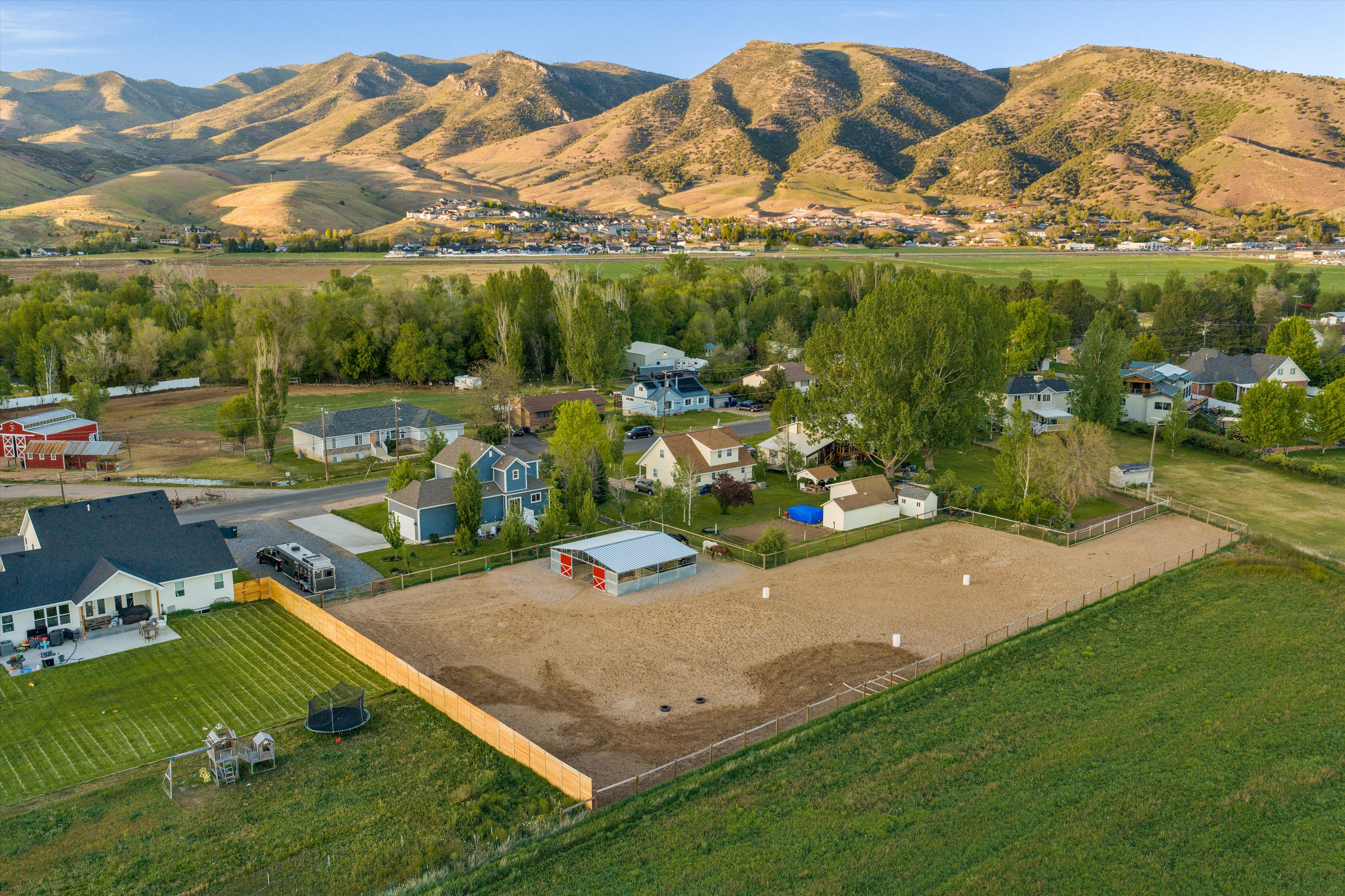 Expansive property featuring a large arena area and a perimeter fence