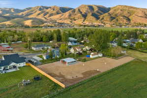 Expansive property featuring a large arena area and a perimeter fence
