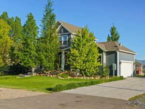 Two-story residence featuring blue siding and white trim accents