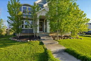 Two-story residential exterior with gray siding and white trim