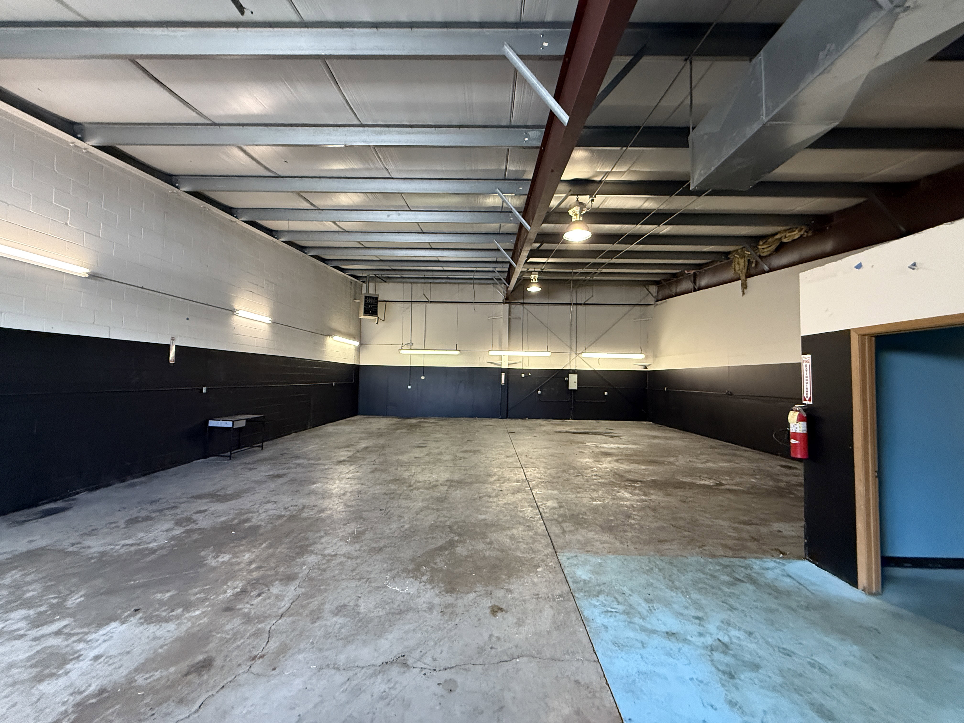 Spacious interior with exposed structural beams and high ceilings