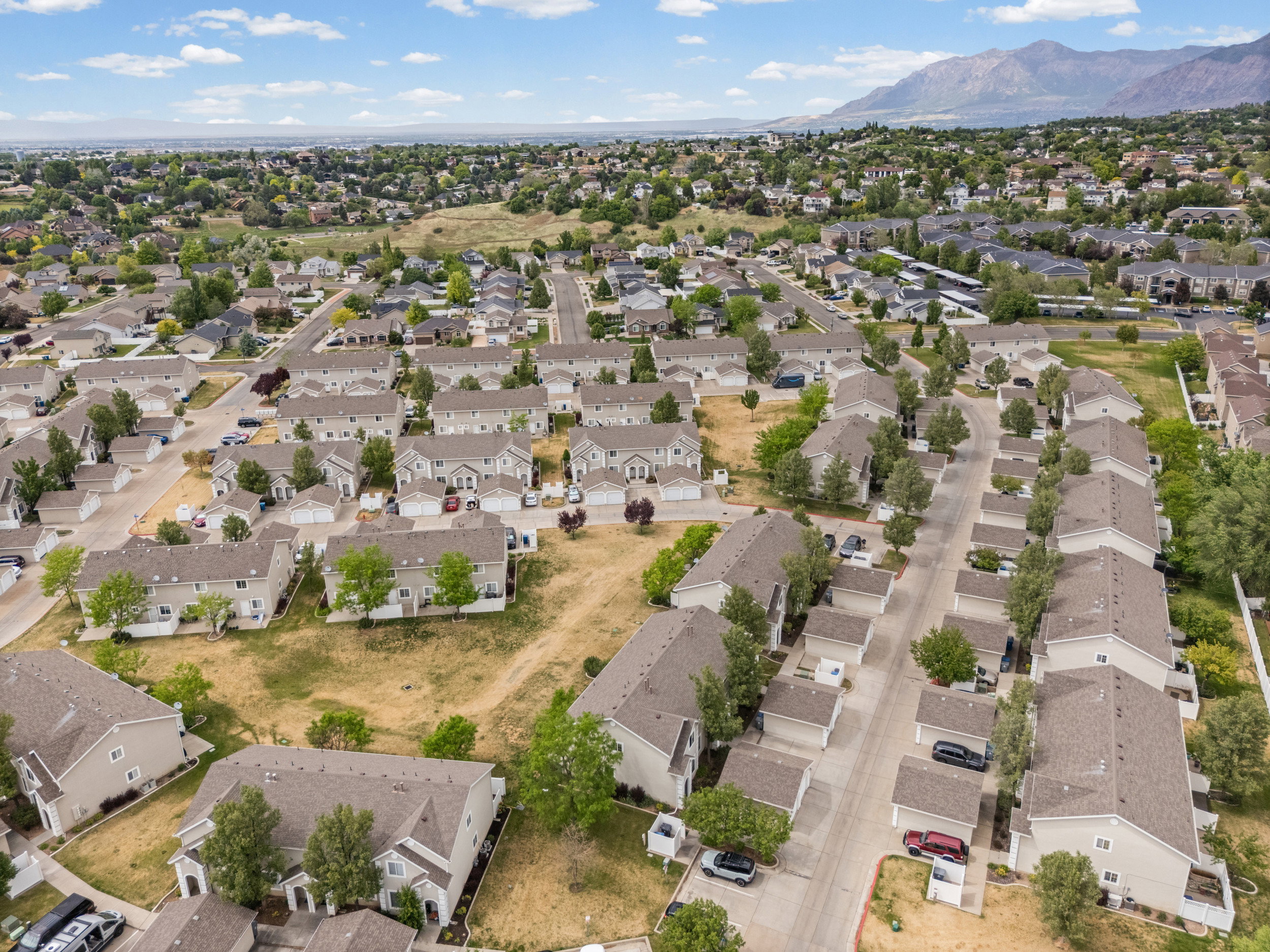 Aerial perspective showcasing a residential community with numerous townhomes