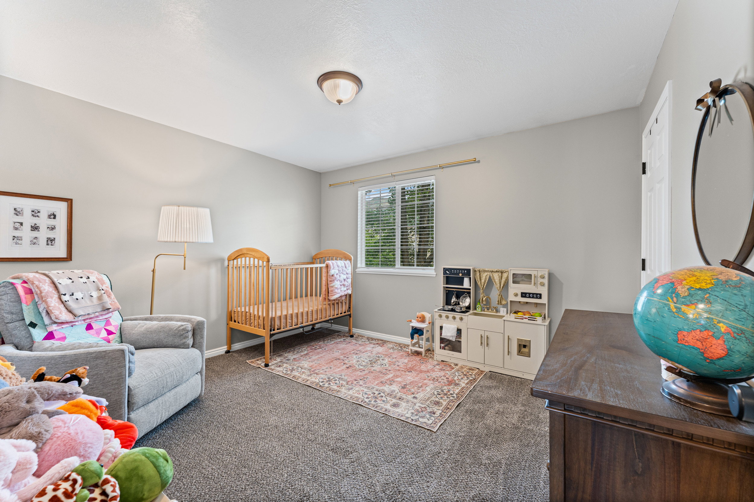 Neutral-toned room featuring light gray walls and dark gray carpet