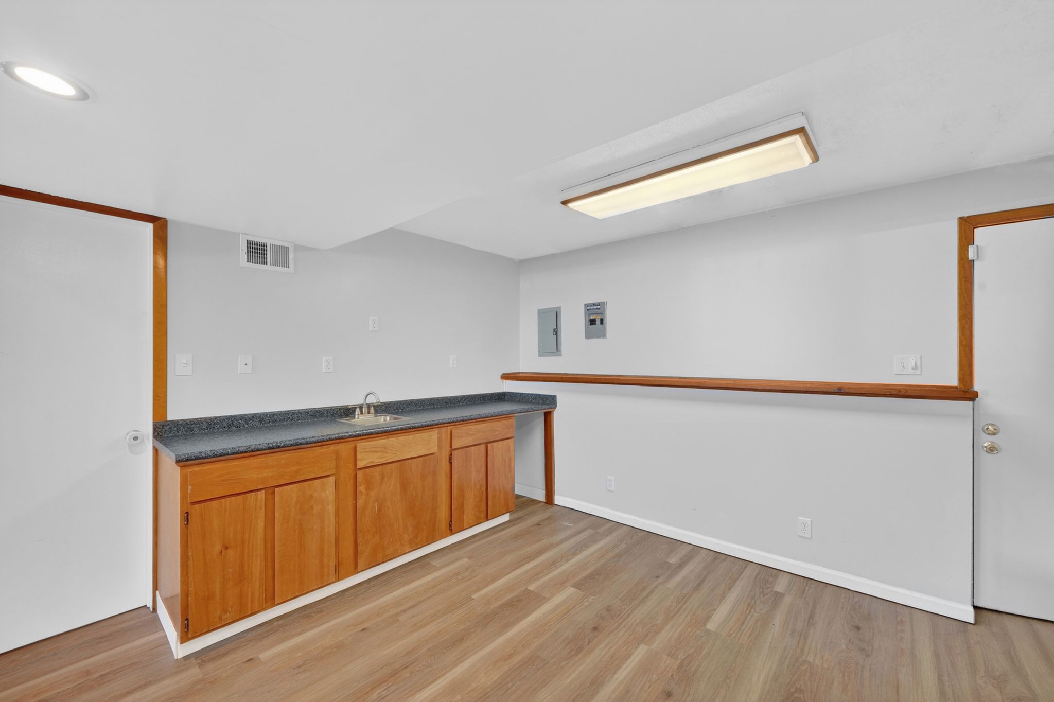 Lower level entertainment space featuring wood-finish flooring