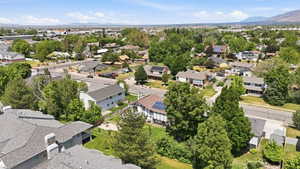 Residential neighborhood featuring mature trees and a clear mountain backdrop