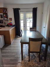 Kitchen area featuring wood-finish flooring, light-colored countertops, and oak-tone cabinetry