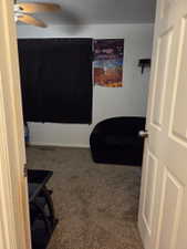 Carpeted interior space with a ceiling fan