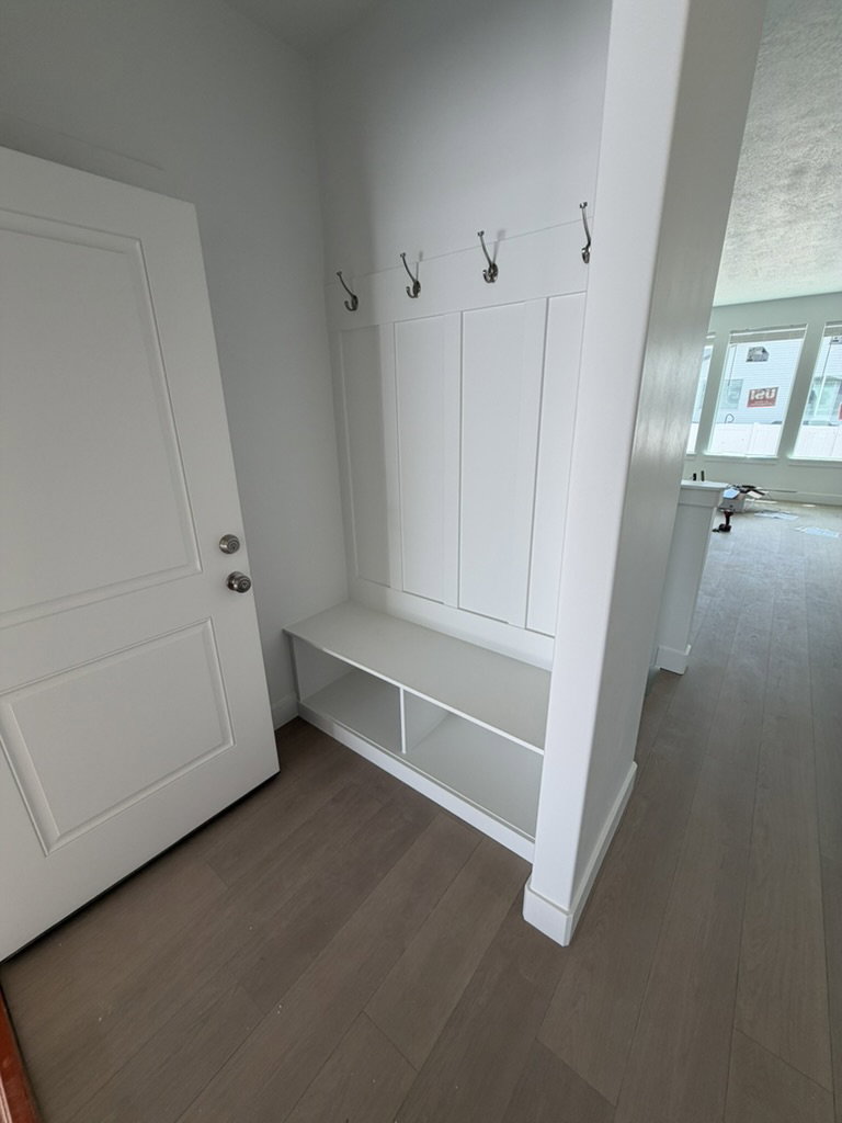Entryway mudroom with built-in bench seating and storage cubbies