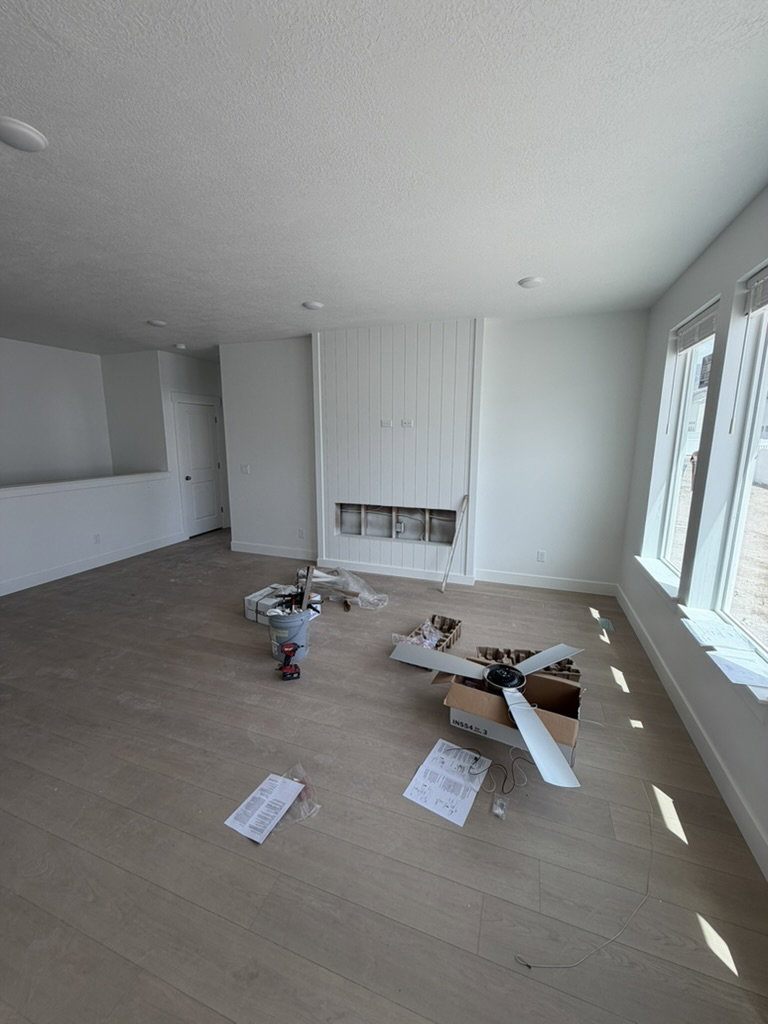 Open concept living space featuring wood-finish flooring and recessed lighting