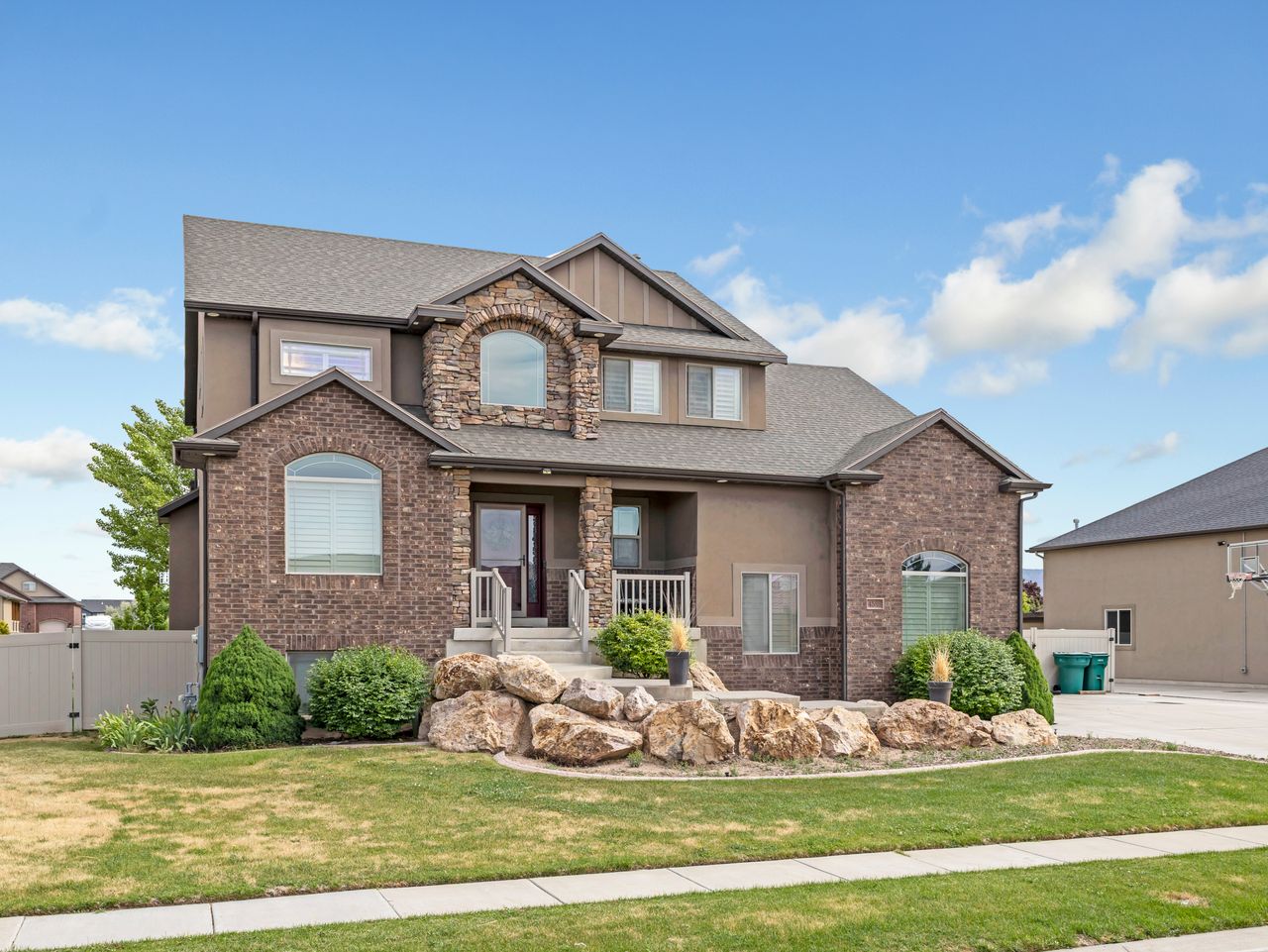 Two-story residence featuring a combination of brick and stucco exterior finishes