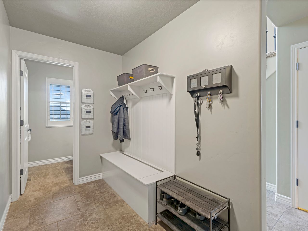 Entryway featuring tile flooring, white baseboards, and neutral wall tones