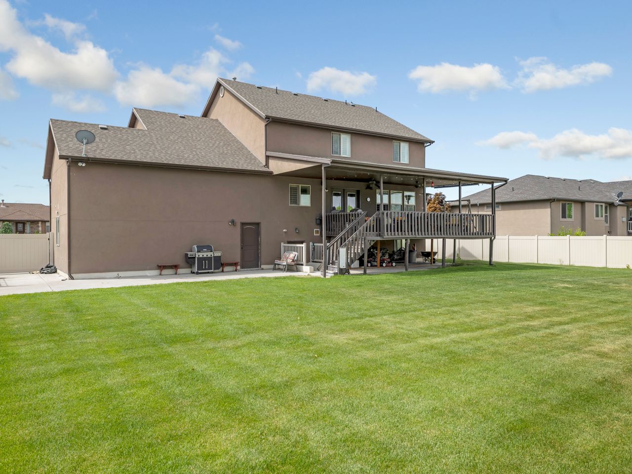 Expansive green lawn with a privacy fence