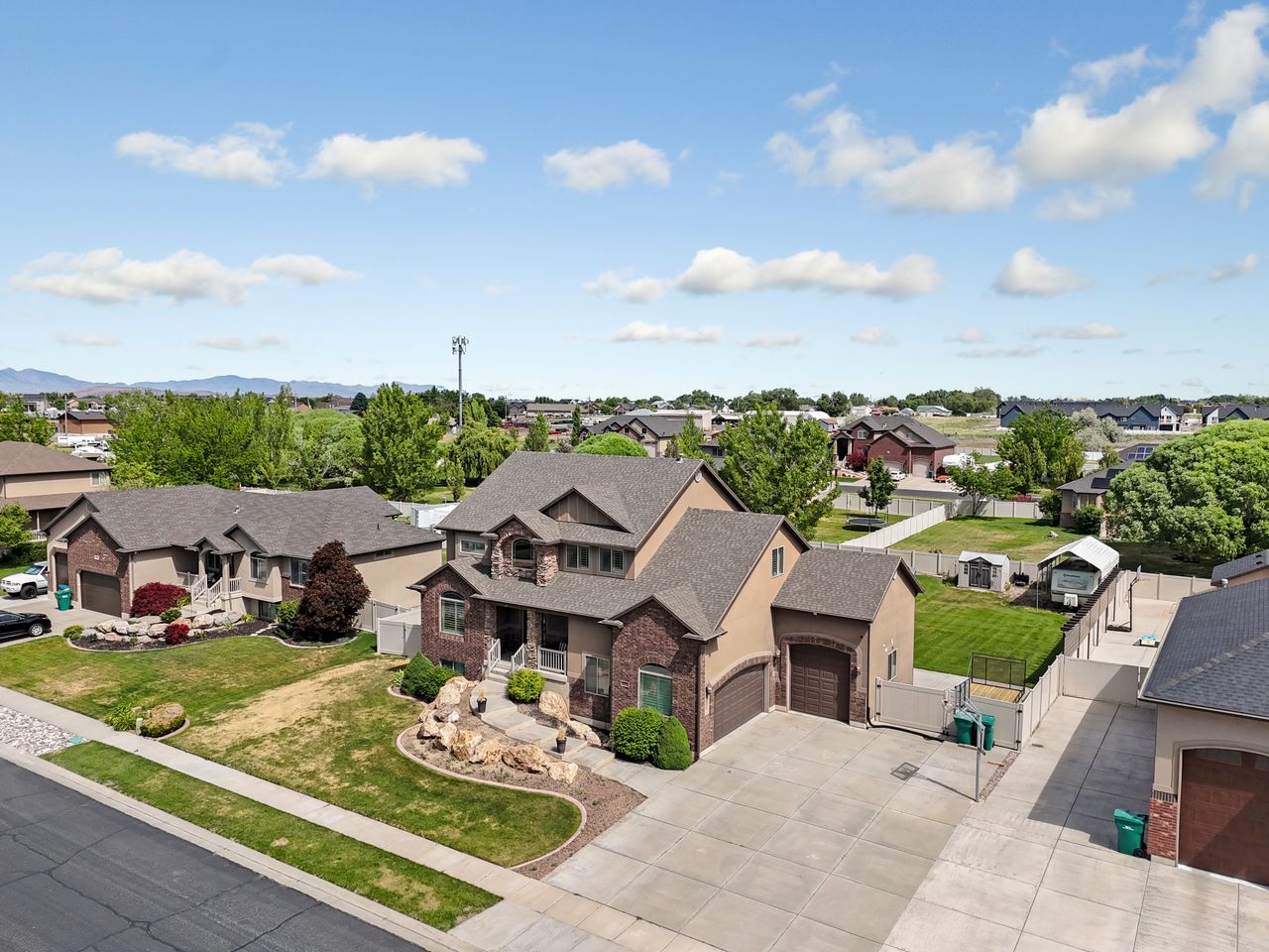 Two-story residential exterior featuring a combination of brick and stucco siding