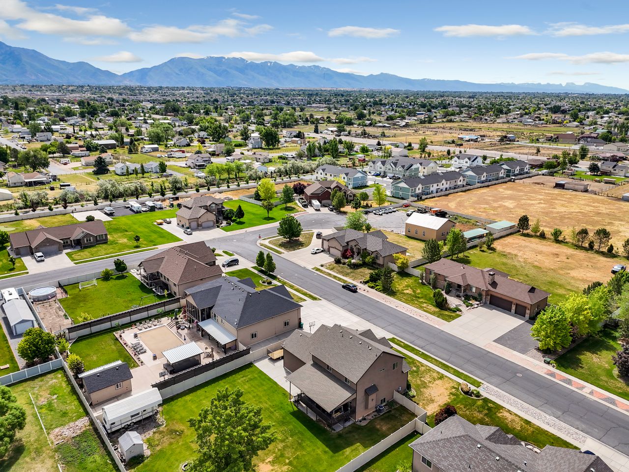 Aerial perspective showcasing a residential neighborhood with distant mountains