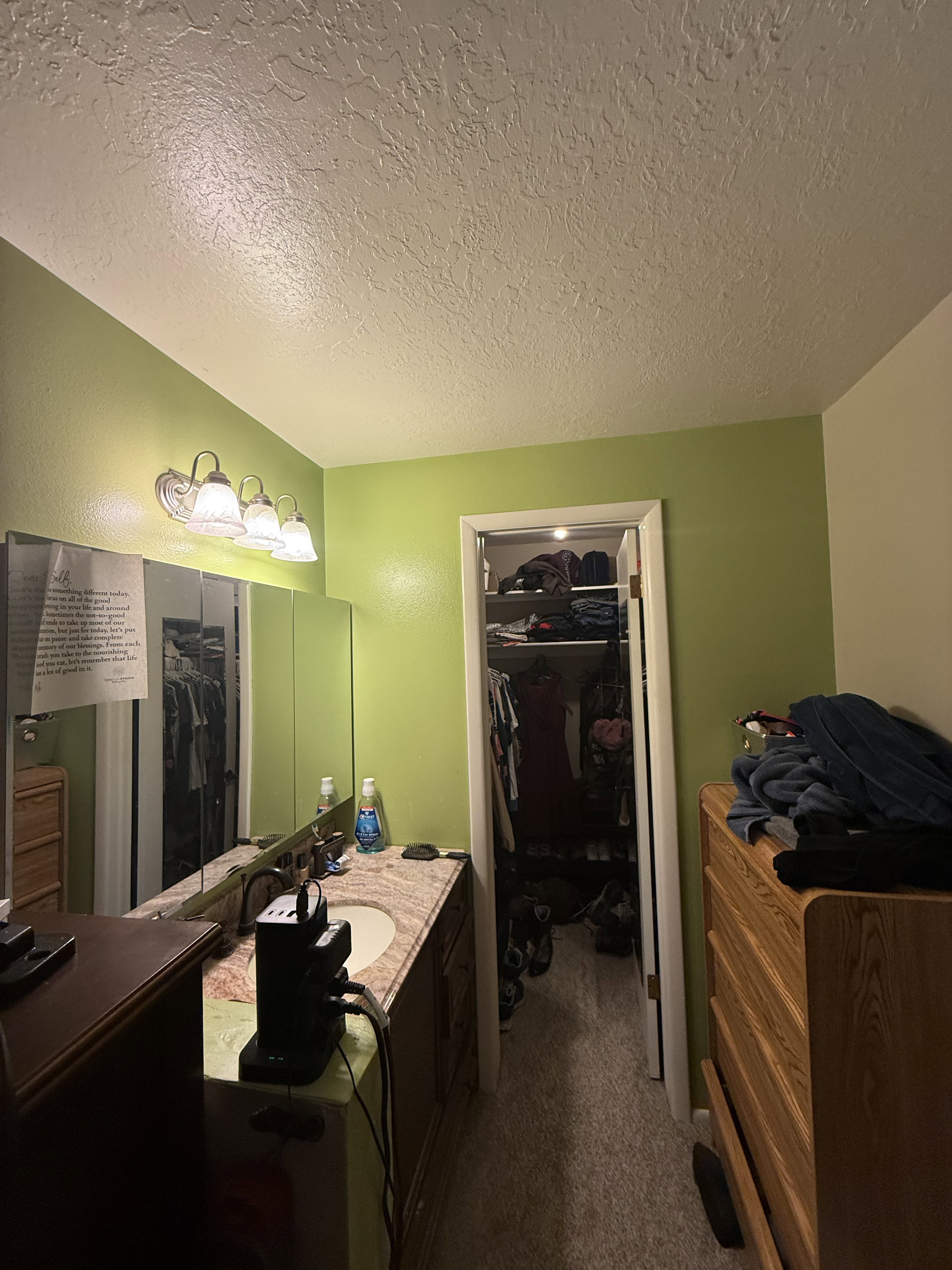 Vanity area featuring a single basin, undermount sink, and a stone-finish countertop