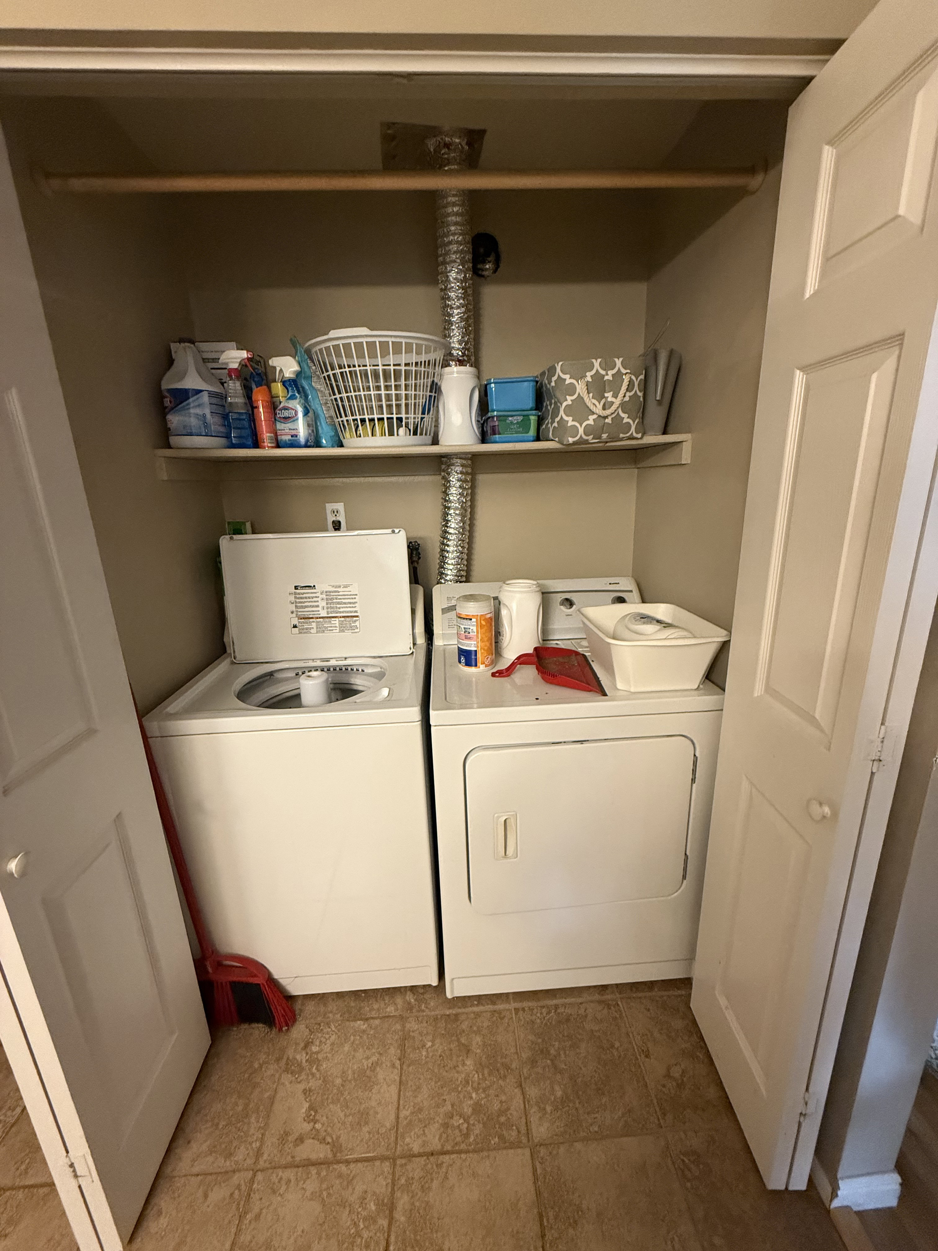 Dedicated laundry closet featuring a top-load washer and front-load dryer