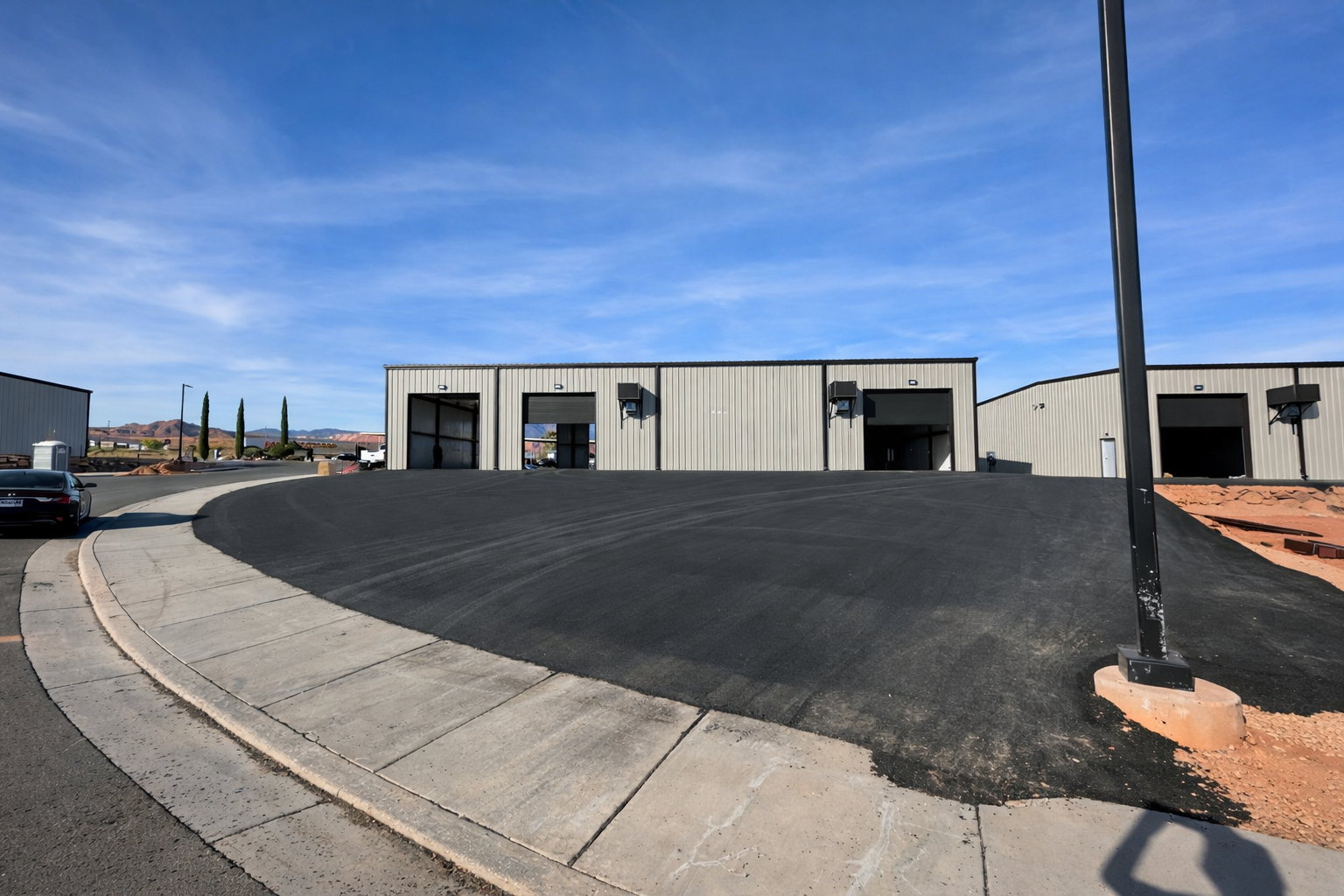 Industrial-style buildings featuring metal siding and multiple roll-up doors
