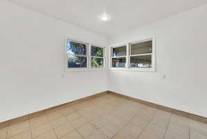 Bright interior space featuring white walls and a recessed ceiling light