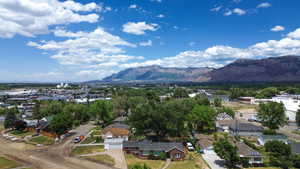 Mountain range backdrop with a residential neighborhood and mature trees