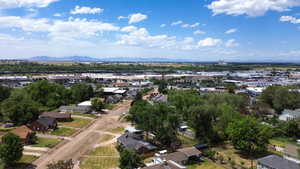 Aerial perspective showcasing residential properties with surrounding commercial areas and distant mountains