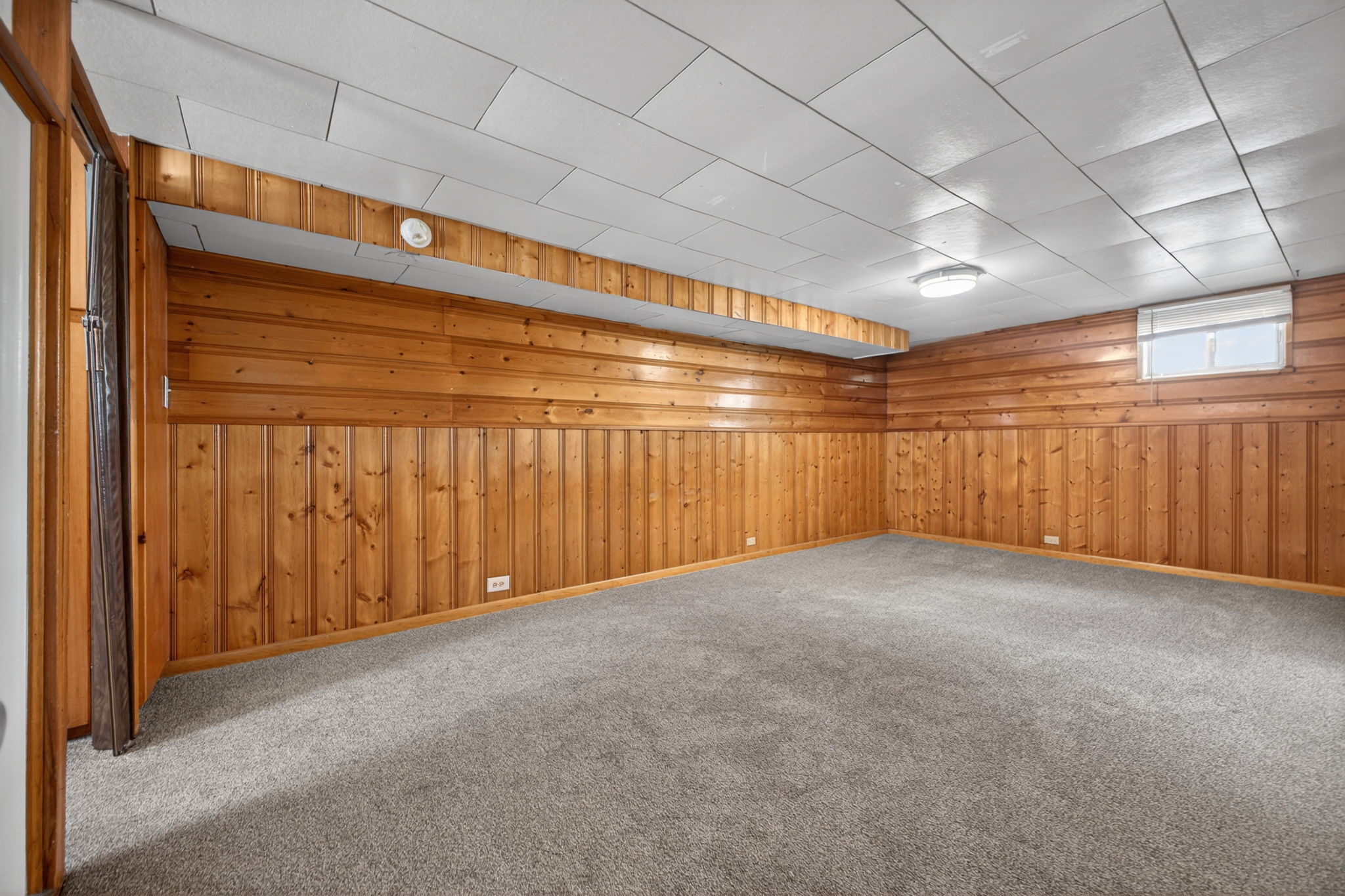 Classic knotty pine paneling in the big family room down.