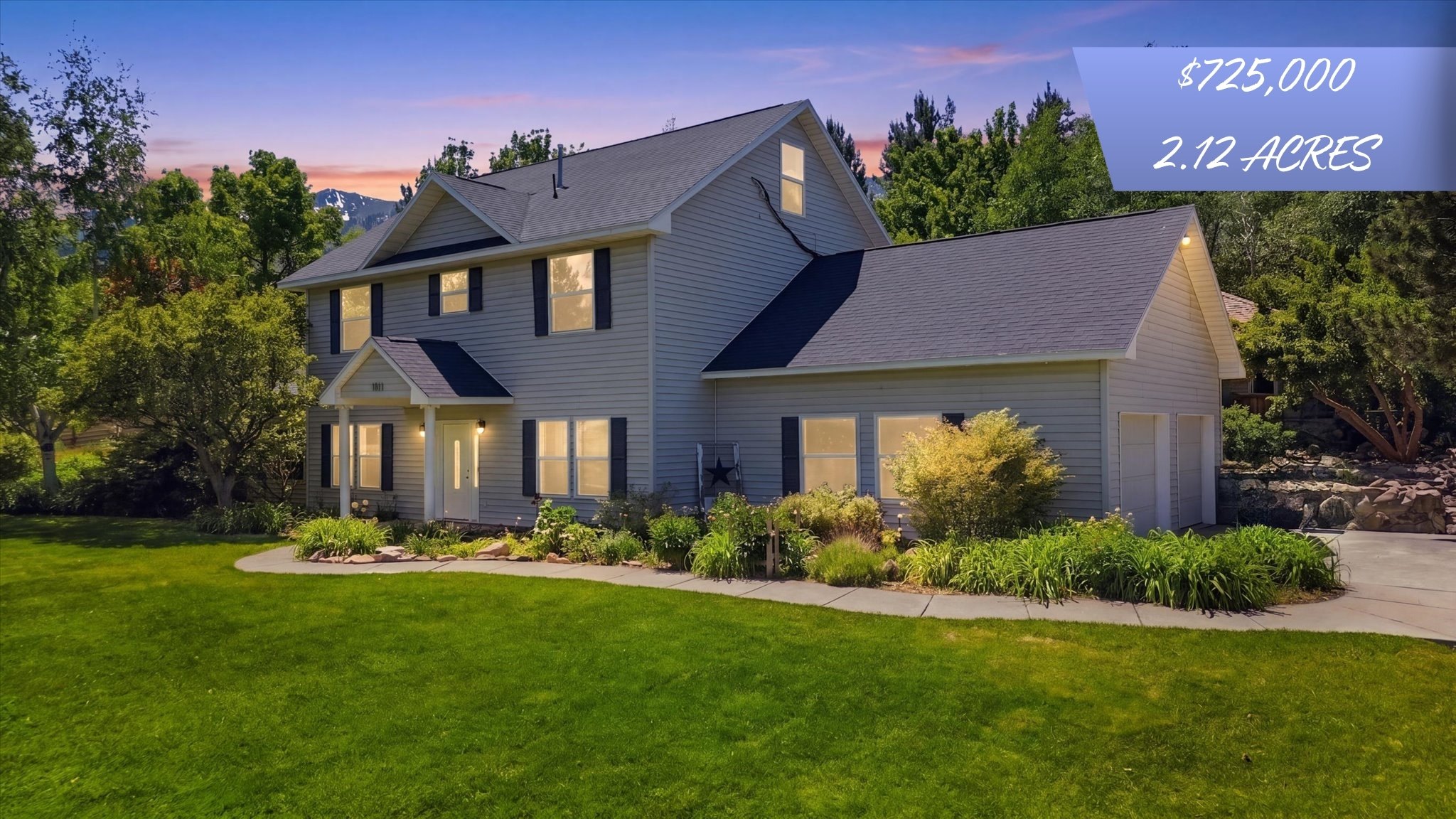 Two-story traditional residence featuring light-toned siding and dark shutters