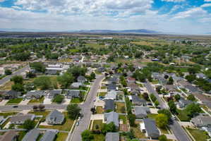 Residential neighborhood featuring a grid-style street layout, mature landscaping, and a distant mountain range