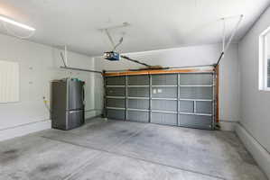 Attached garage with a gray sectional door and automatic opener