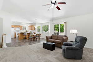 Open-concept living area with vaulted ceiling and ceiling fan