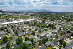 Aerial perspective of a residential community featuring single-story homes with varied rooflines