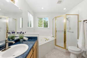 Bathroom featuring a single vanity with a blue countertop, an undermount sink, and a brushed nickel faucet