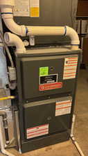 New Goodman high efficiency furnace with white PVC venting and gas line connection