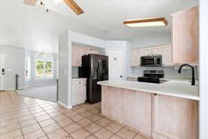 Kitchen featuring light-finish cabinetry, white countertops, and tile flooring