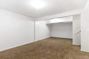 Carpeted room featuring white walls, white trim, and a ceiling-mounted light fixture
