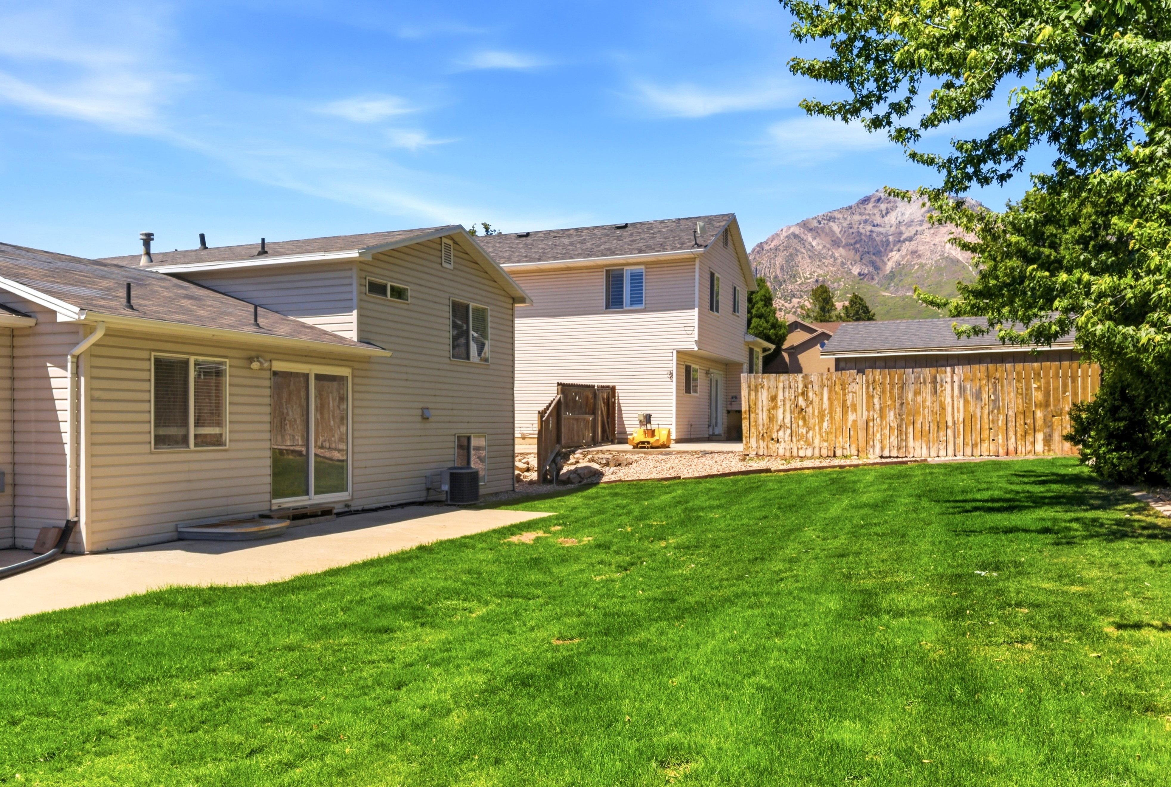Expansive green lawn with mountain backdrop