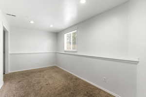 Carpeted room featuring a white interior, recessed lighting, and a single window