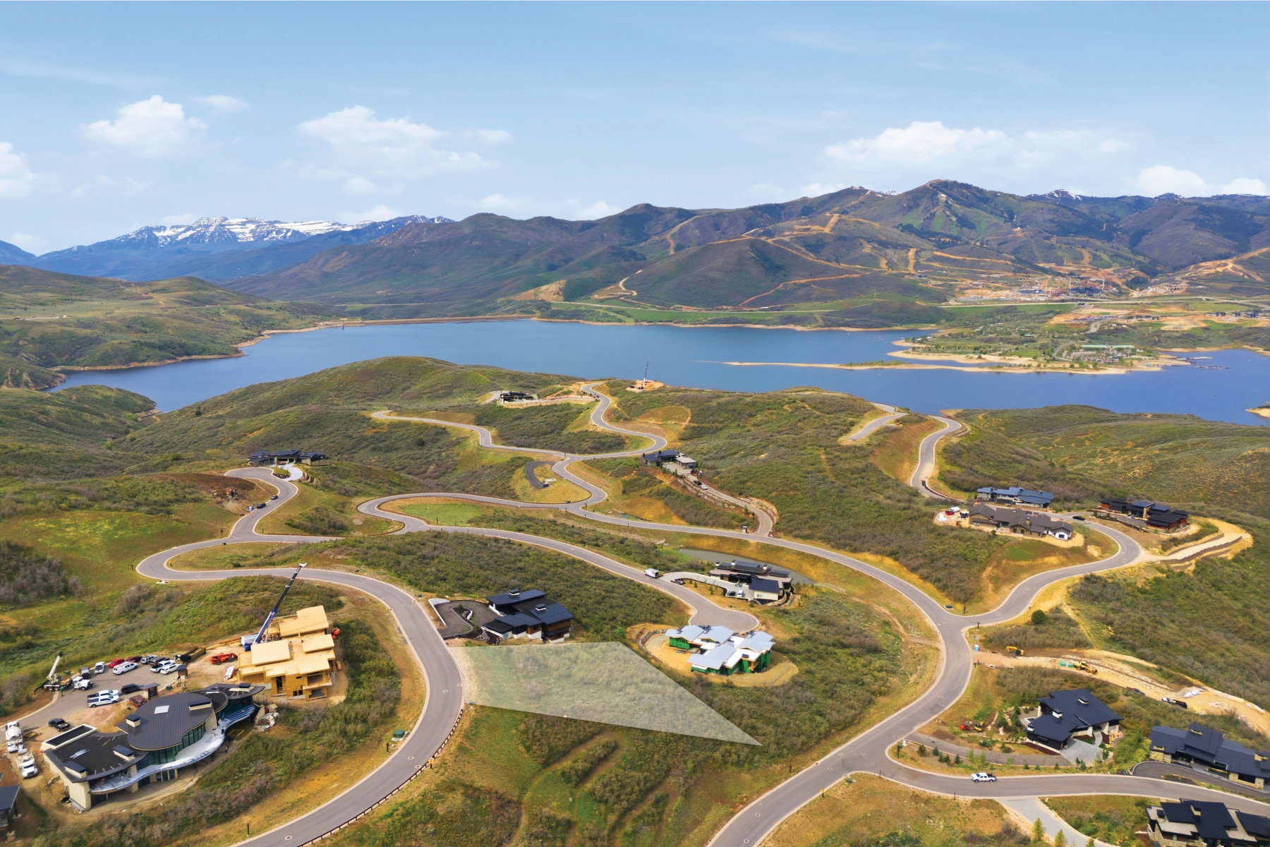 Aerial perspective highlighting a building lot with terraced surroundings and paved roadways