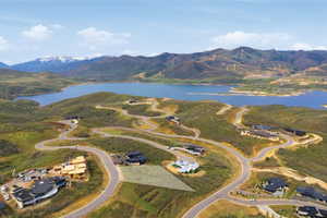 Aerial perspective highlighting a building lot with terraced surroundings and paved roadways