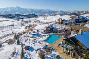 Expansive property featuring multiple structures, a multi-lane outdoor pool, and several additional pools/spas