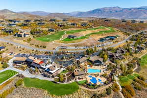 Expansive aerial showcasing a golf course environment with multiple residential properties